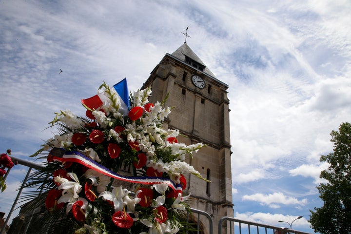 Flowers pay tribute to French priest Father Jacques Hamel outside the parish church at Saint-Etienne-du-Rouvray.