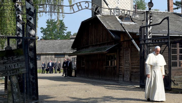 Pope Francis walks through the entrance of the former Nazi death camp of Auschwitz in Oswiecim