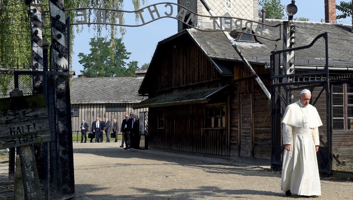 Pope Francis walks through the entrance of the former Nazi death camp of Auschwitz in Oswiecim