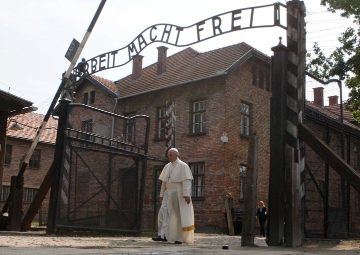 Pope Francis walks through a gate with the words "Arbeit macht frei" (Work sets you free) at the former Nazi German concentration and extermination camp Auschwitz-Birkenau in Oswiecim, Poland, on Friday.