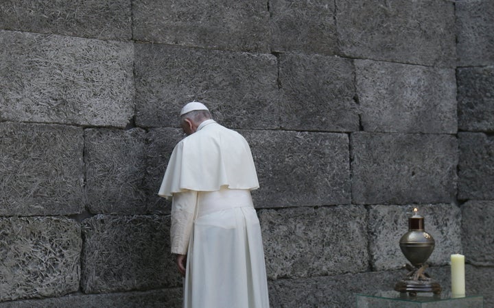 Pope Francis pays respects by the death wall in the former Nazi German concentration and extermination camp Auschwitz-Birkenau in Oswiecim, Poland.