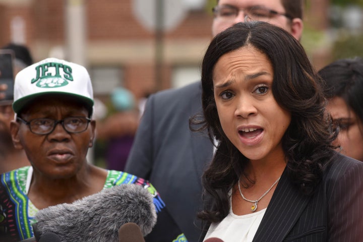 Baltimore State's Attorney Marilyn Mosby holds a news conference on Wednesday, July 27, 2016, at the corner where Freddie Gray was taken into police custody, after dropping the charges against the three remaining officers to be tried in his death. At left is Gray's stepfather, Richard Shipley.