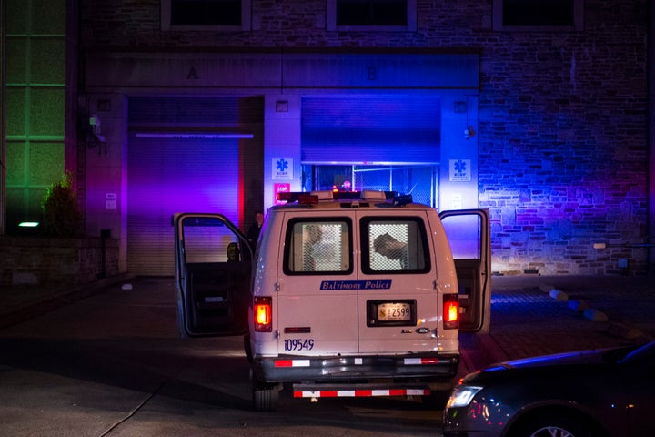 Police vans entered the Baltimore Central Booking and Intake Center as people marched around the city in solidarity with Freddie Gray after it was announced that criminal charges would be brought against all six officers involved, May 2, 2015.