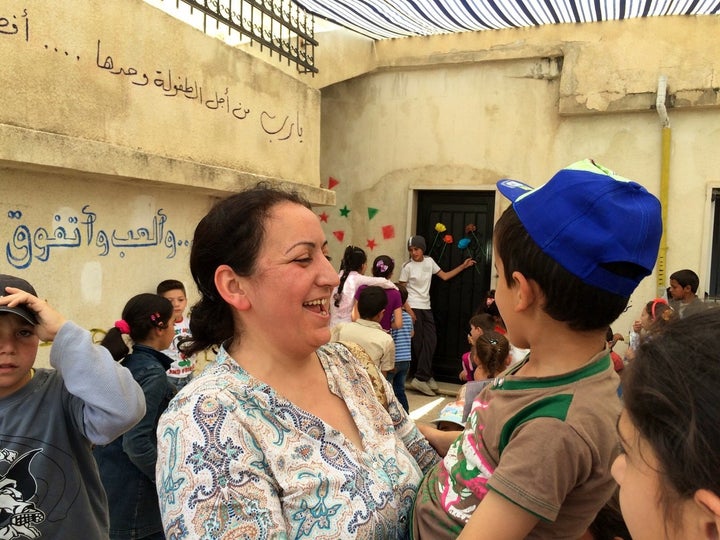 Ola Al-Junde, 43, is a Syrian math teacher who juggles her day job managing one school for Syrian refugee kids with volunteer