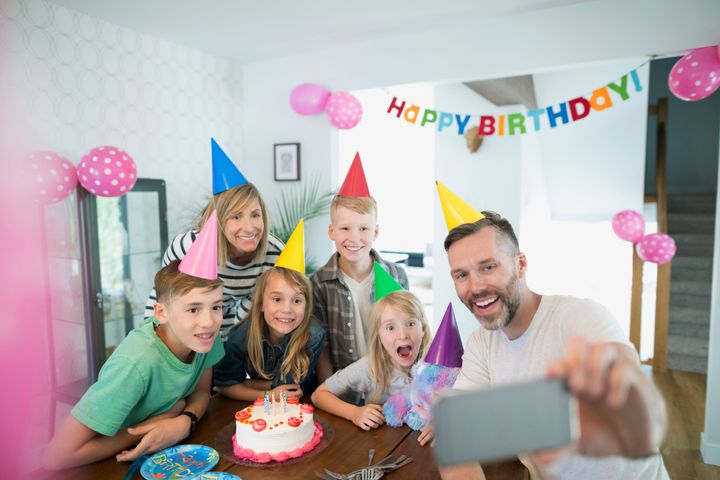Family taking selfie celebrating birthday Hero Images via Getty Images