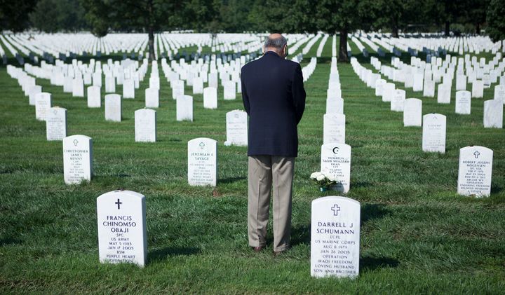 Khizr Khan pauses at the grave of his son in Arlington National Cemetery. 