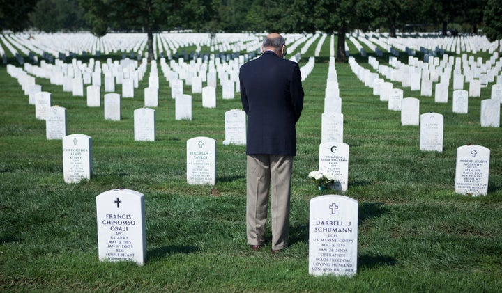 Khizr Khan pauses at the grave of his son in Arlington National Cemetery.