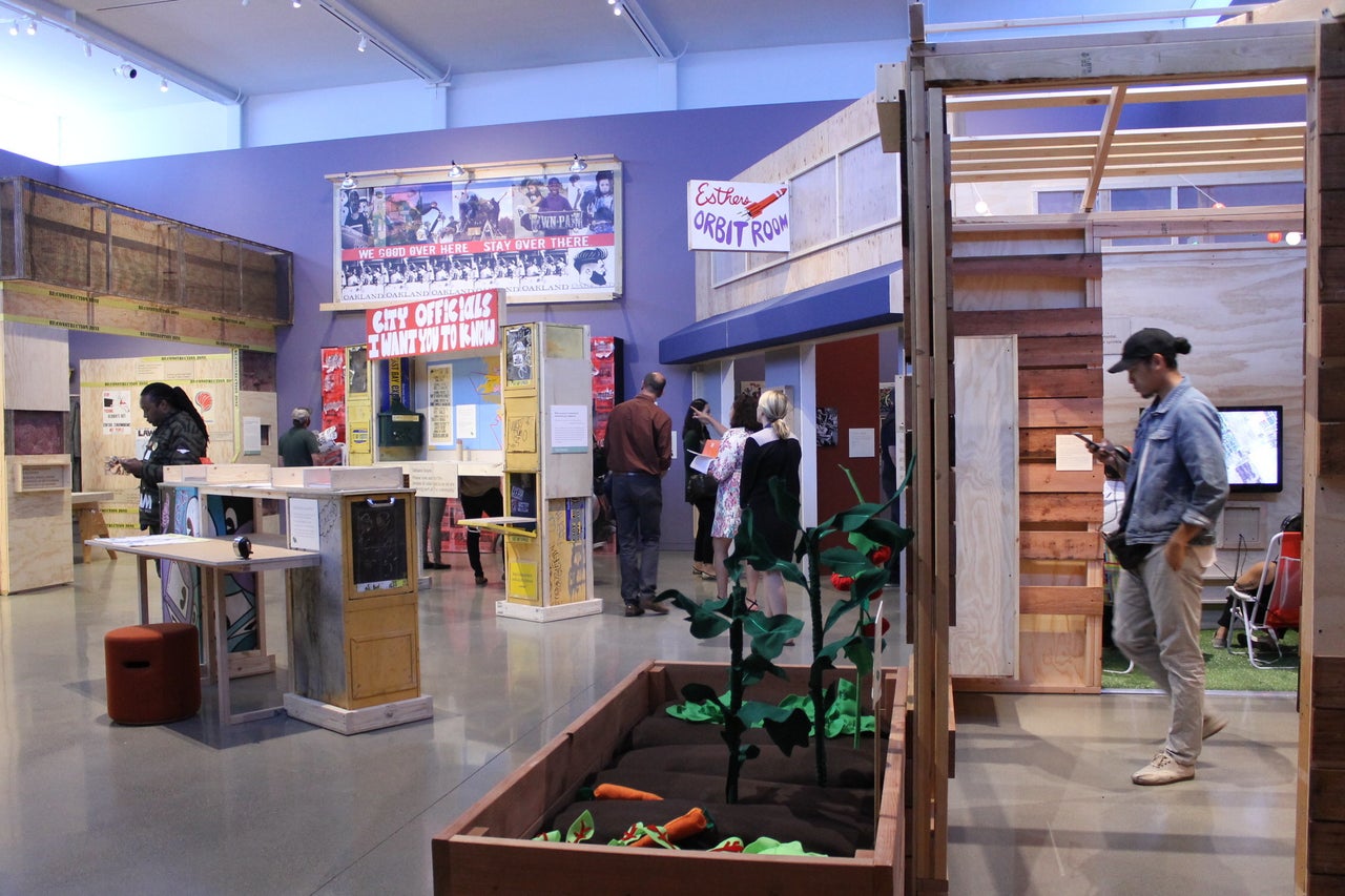 Installation shot of “Oakland, I want you to know...” In the foreground is the community garden installation, with felt vegetables made by textile artist Angie Wilson.