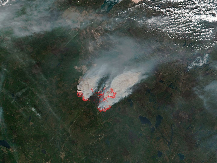 NASA's satellite image shows columns of smoke rising up from the myriad of wildfires, with NASA outlining actively burning areas in red over the Fort McMurray, Alberta, Canada on May 16, 2016