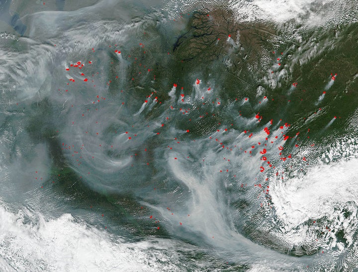 "Many wildfires continue pepper central Russia and created a portrait of swirling smoke in a satellite image. The Suomi NPP satellite's Visible Infrared Imaging Radiometer Suite (VIIRS) instrument identified smoke and heat from many wildfires on July 18, 2016 at 06:30 UTC (2:30 a.m. EDT). In the image the red area indicate hotspots and the location of the fires." -- NASA