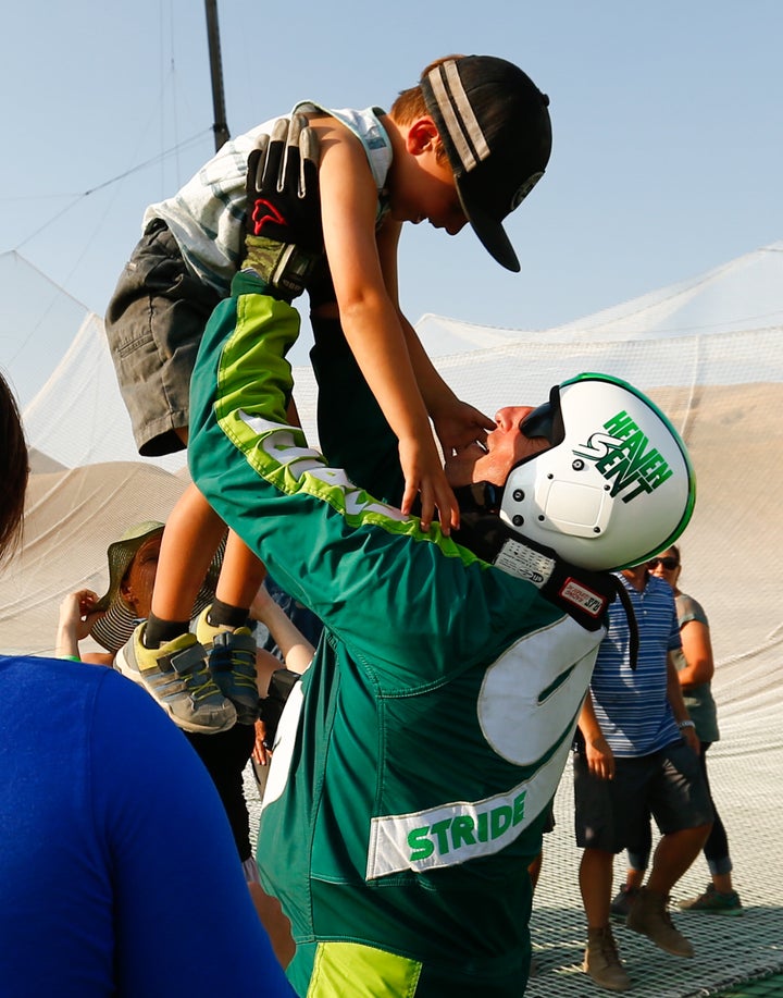 Skydiver Luke Aikins celebrates with son Logan after jumping 25,000 feet from an airplane without a parachute or wing suit on July 30, 2016 in Simi Valley, California.