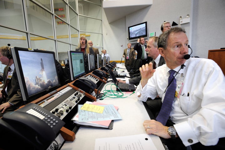 NASA administrator Michael Griffin turns from his console to watch the liftoff of space shuttle Atlantis through the windows of the Launch Control Center at Kennedy Space Center in February 2008.