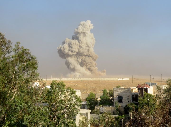 Smoke rises after anti-regimist opposition forces hit Assad regime forces' base in Aleppo.