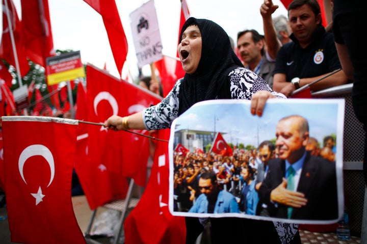 Supporters of Turkish President Tayyip Erdogan wave Turkish flags during a pro-government protest in Cologne, Germany on Sunday. German authorities prevented Erdogan addressing the rally.