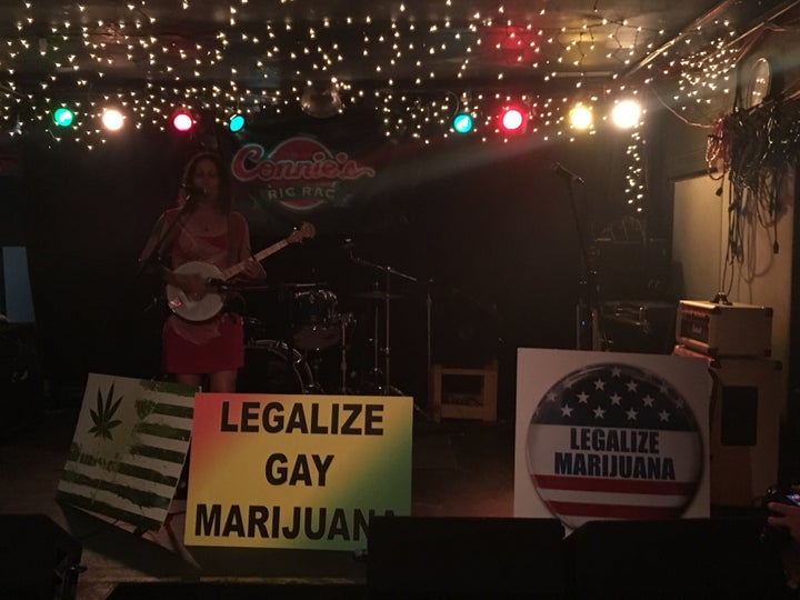 Emily Yates sings an antiwar ballad at the "DNC Marijuana Welcome Party" at Connie's Ric Rac on July 25.