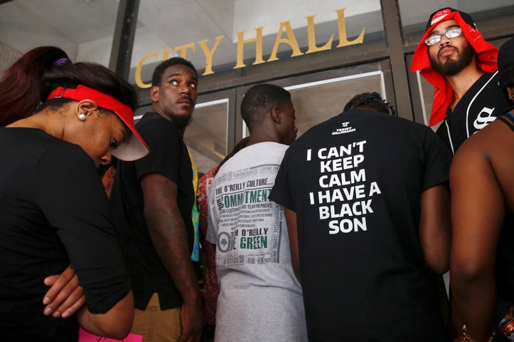 Demonstrators protesting the death of Alton Sterling stand in front of the East Baton Rouge Parish City Hall doors in Baton Rouge, Louisiana, on July 11.