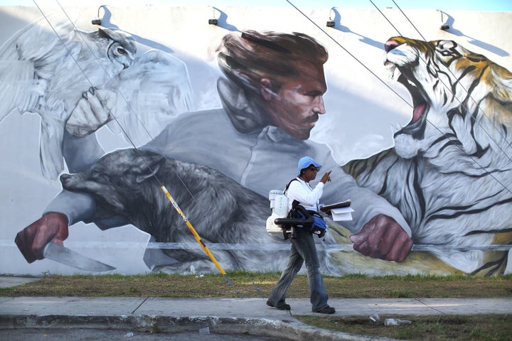 MIAMI, FL - JULY 30: Sharon Nagel, a Miami-Dade County mosquito control inspector, walks through the Wynwood neighborhood looking for mosquitos or breeding areas where she kills the mosquitoes with larvicide granules or a fogger spraying pesticide as the county fights to control the Zika virus outbreak on July 30, 2016 in Miami, Florida.