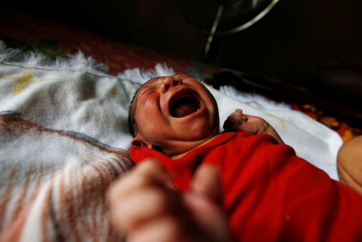 Eight-day old baby Allan, who was born with microcephaly, cries at home in Choluteca, Honduras, July 29, 2016.