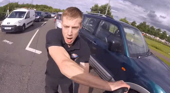 <strong>The motorist can be seen shoving the motorcyclist during the road rage incident in Scotland</strong>