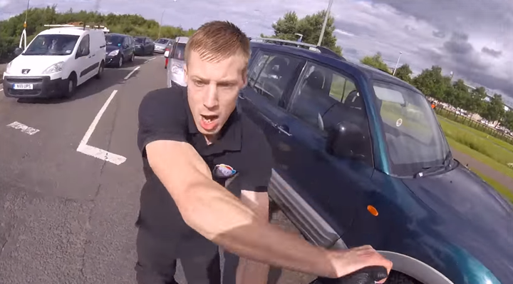 The motorist can be seen shoving the motorcyclist during the road rage incident in Scotland