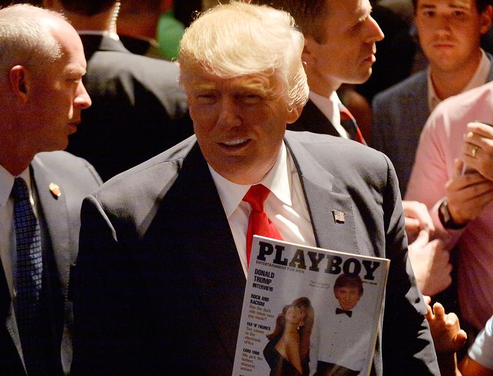 Republican presidential nominee Donald Trump shows a police officer his photo on the cover of a Playboy magazine during a campaign event at the Duke Energy Center for the Performing Arts on July 5 in Raleigh, North Carolina.
