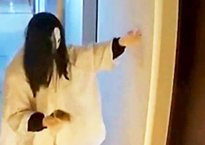 A Japanese 'ghost' has been caught on film smearing poo on a woman's front door