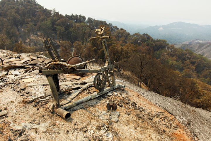 A scorched exercise bike sits on the edge of a slope at the site of a destroyed house after the Soberanes fire.