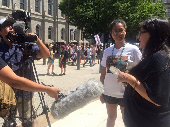 Jake Hoyungowa of Paper Rocket Productions filmmaker team, and Kendra Bird In the Sky, interview a participant in the Clean Energy Revolution March, Philadelphia, July 23, 2016