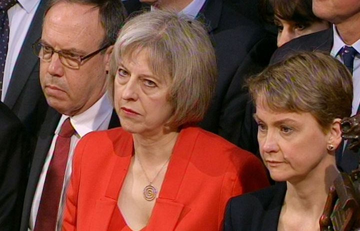 Theresa May (centre) was branded a 'complete disgrace' by Yvette Cooper (right)