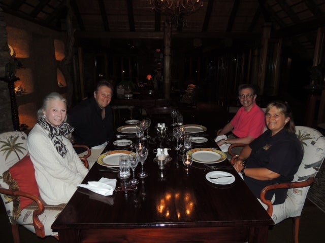 Guests enjoy a candlelit dinner in camp