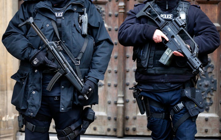 Armed police officers stand guard at the Houses of Parliament in London.