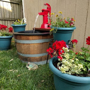 Rework a wine barrel into an outdoor water pump.