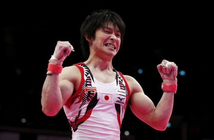 Kohei Uchimura celebrating his sixth world title at the World Gymnastics Championships, but he isn't celebrating his pho