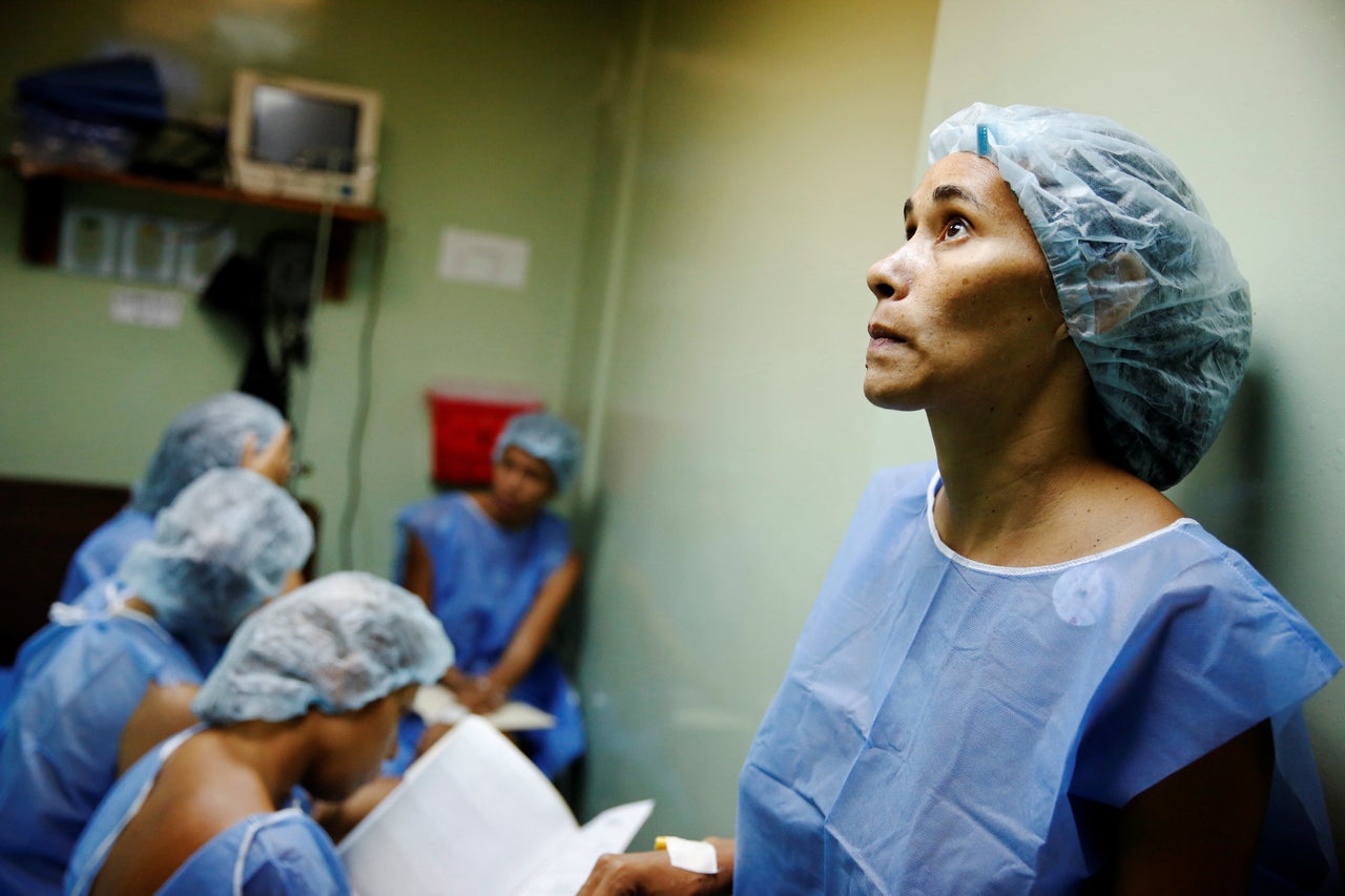 A woman waits for sterilization surgery a hospital in Caracas, Venezuela on July 27, 2016.