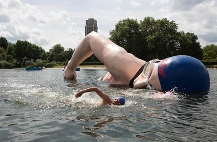 <strong>Rebecca swims alongside her tribute statue in London's Serpentine</strong>