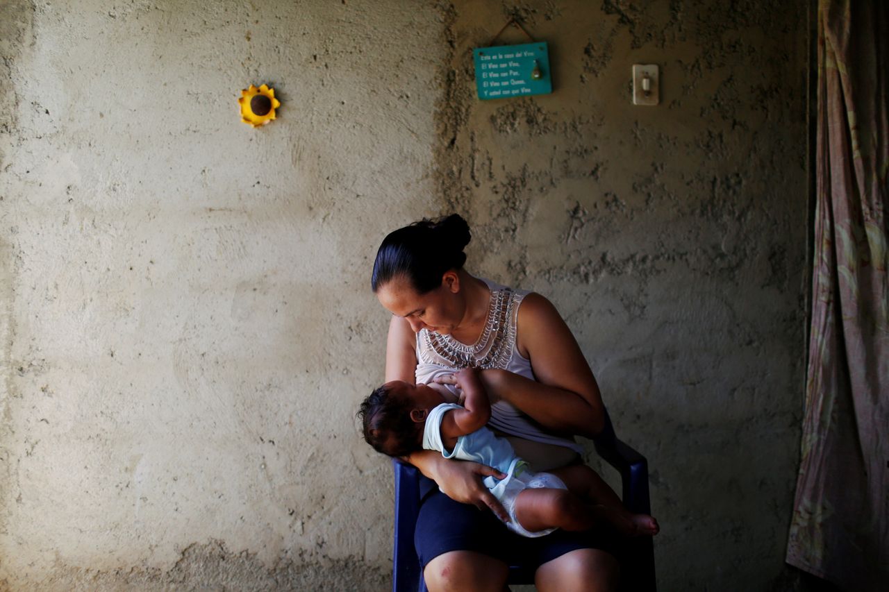 Emileidy Ojeda, 26, breastfeeds her four-month-old son David, ahead of her sterilization surgery, at their house in San Francisco de Yare, Venezuela on July 11, 2016.
