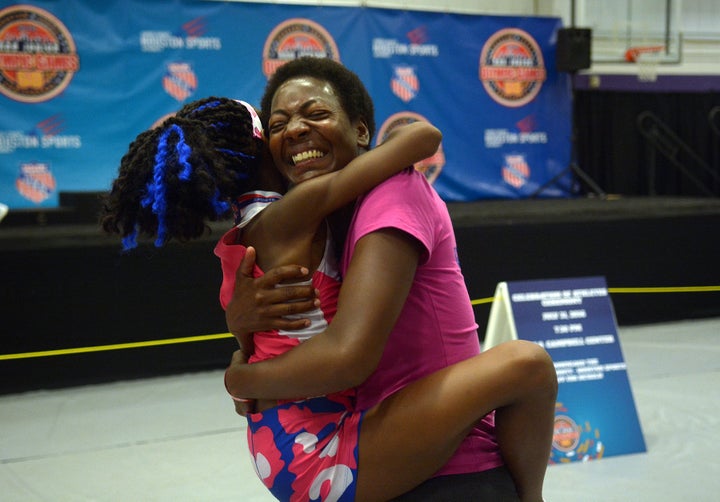 Rainn Sheppard shares a hug with her mom, Tonia Handy, who surprised Rainn by showing up to watch her compete in the Girls 3000 Meter race at the 2016 AAU Junior Olympic Games at Turner Stadium in Humble, Texas, on Monday, Aug. 1, 2016.