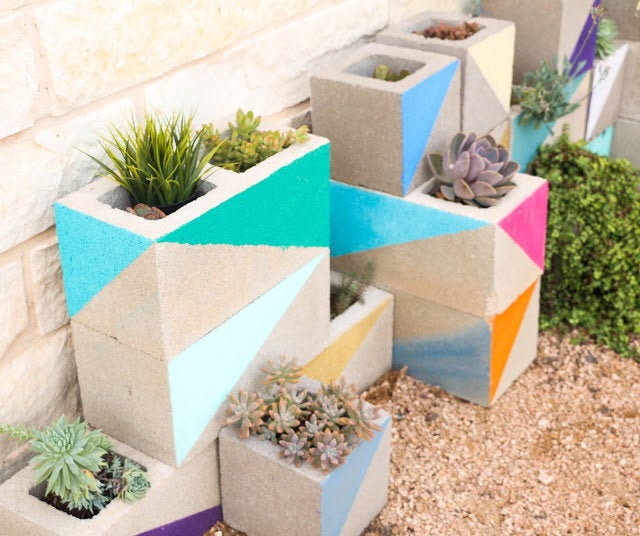 Decorated cinder blocks make for a colorful home for plants.