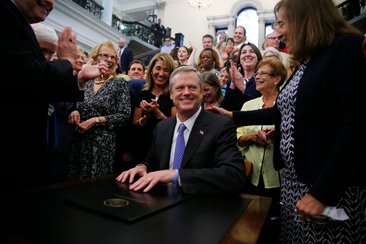 The Republican governor of Massachusetts, Charlie Baker, signing the pay equity law on August 1 surrounded by some very happy women.