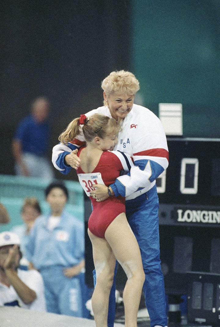 Kim Zmeskal and Martha Karolyi celebrate after Zmeskal finishes her bar routine at a 1990 meet.