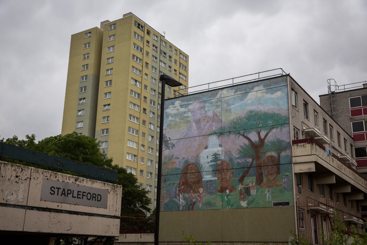 A mural shows Bob Marley, John Lennon and Gandhi.