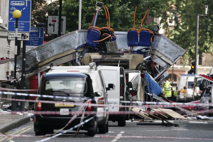 A policeman stands amongst the wreckage of a double-decker London bus which was ripped apart by an explosion in Russell Square in central London.