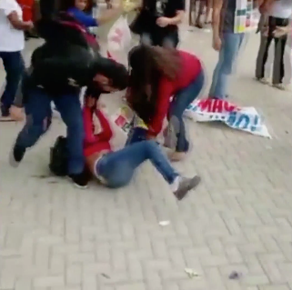 One of the protesters falls to the ground after the officer fires