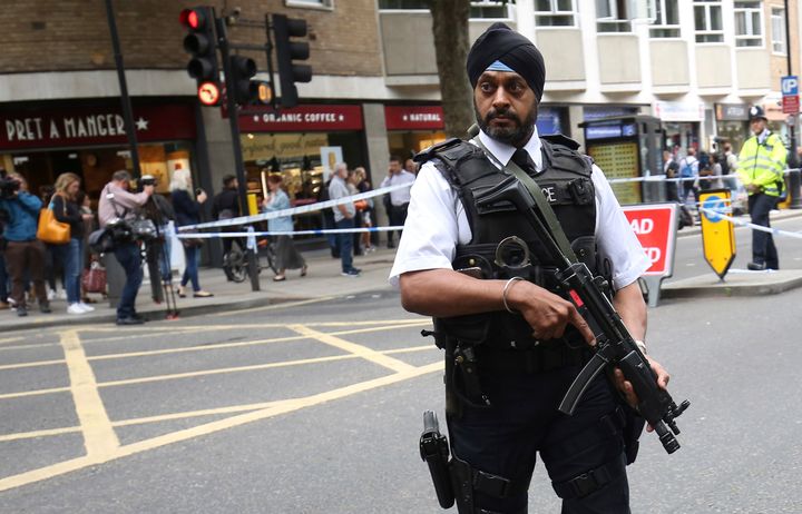 <strong>An armed officer stands guard at the scene of the knife attack in Russell Square in London</strong>