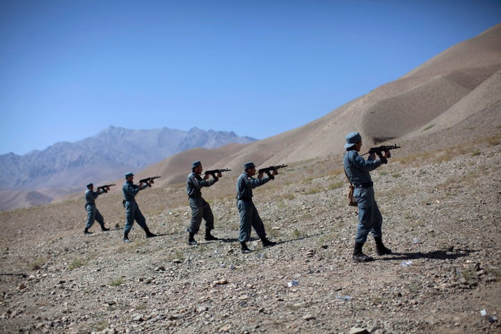 Afghan policemen train at a live firing range in the central province of Bamiyan, which has marketed itself as a tourist destination.