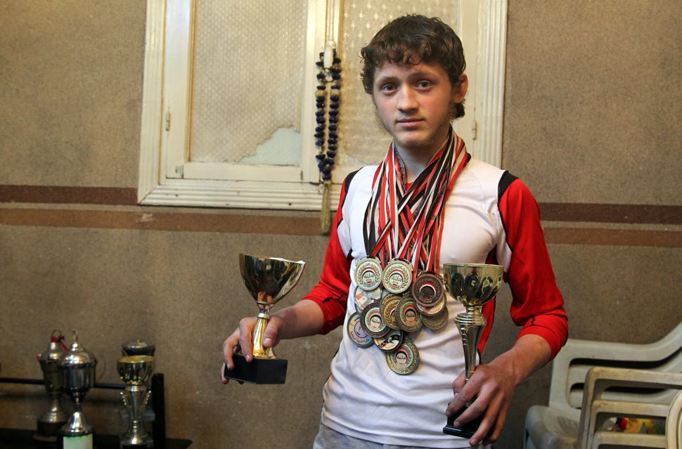 Al-Sawas poses with his medals and trophies at his home in Bustan al-Qasr in March. Supporting the anti-