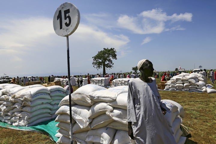 A man waits to receive food provided by the United Nations' World Food Programme (WFP) during a visit by a European Union del