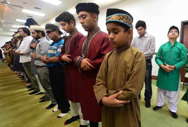 Muslims pray while celebrating Eid al-Fitr, marking the end of fasting during the month-long Ramadan, at the Baitul Hameed Mo