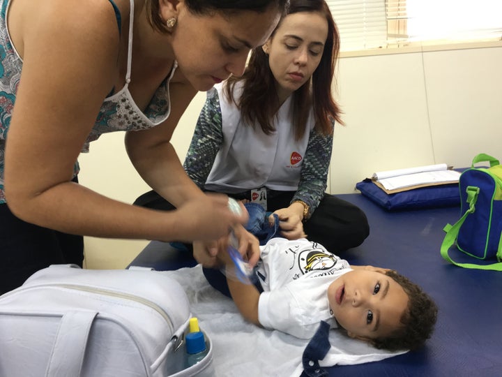 Adriana Da Silva, left, takes her son José Bernardo to the AACD clinic, where Dr. Ana Patrícia, right, treats his learning disabilities.