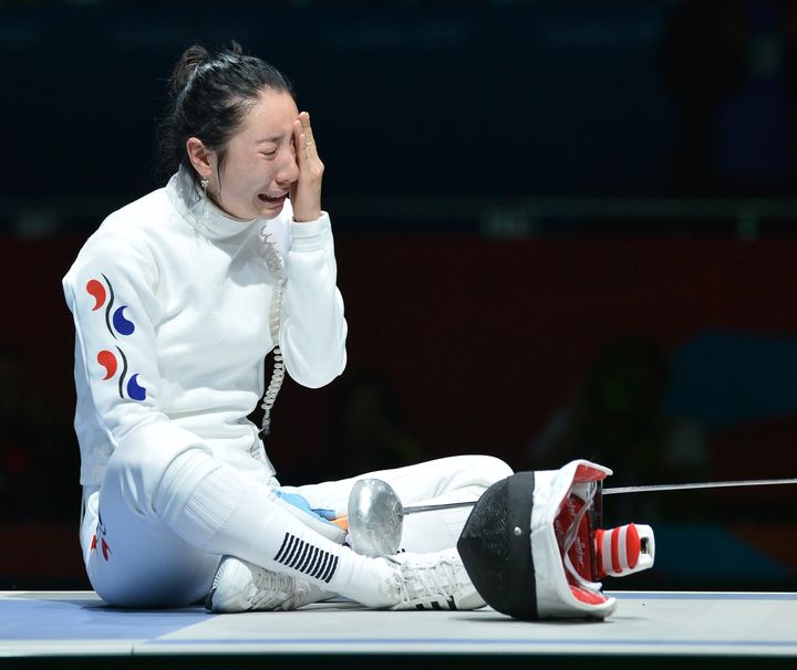 Shin Lam cries as the dispute continues over her match against Britta Heidemann